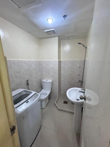 a small bathroom with a sink and a toilet at Davao Cozy Condo T6 unit 2 in Davao City