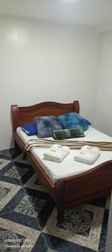 a bed with two pillows on it in a room at HotelSueñosCafeteros in Montenegro