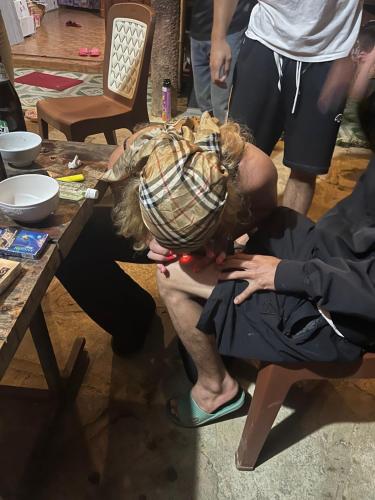 a woman with her head on a table at Aluoi Homestay in Hue