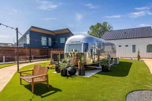 a silver trailer parked in a yard next to a house at Hotel SOMA in Fort Worth