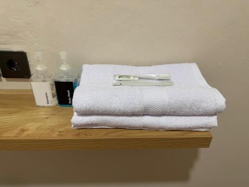 a white towel and a toothbrush sitting on a table at Gassania Hostel in Banda Aceh