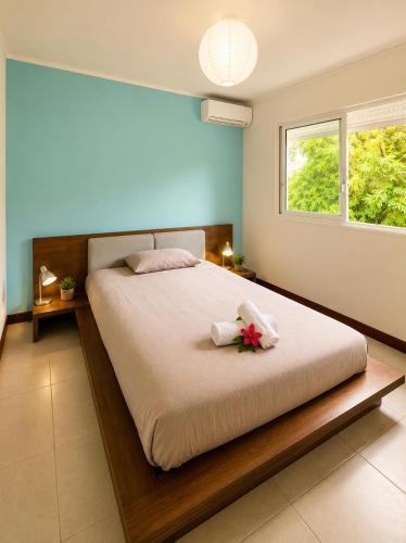 a bedroom with a large bed with flowers on it at Le Nid de Magenta by Gérald Appartement Premium Magenta Terrasse Parking in Noumea