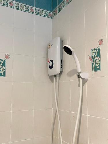 a bathroom with a hair dryer on the wall at Emporium Chiangmai in Chiang Mai