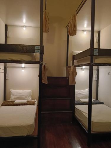 a room with three bunk beds in a hostel at 24 Kimberley in George Town
