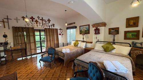 a bedroom with two beds and a table and chairs at Master suite en Teotihuacan in San Sebastian Xolalpa