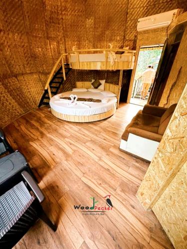a view of a bedroom with a bed and a staircase at Green Nest Resorts in Malebennūr