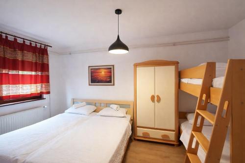 a bedroom with two beds and a bunk bed at Hiša Žičanka in Loče pri Poljčanah