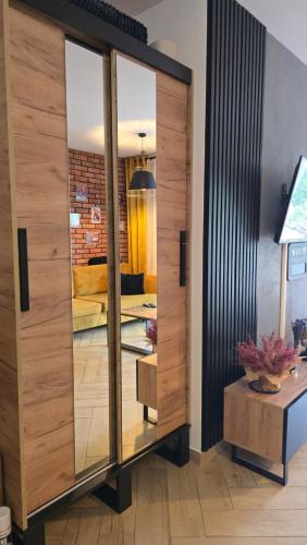 a glass cabinet in a room with a bedroom at Loft Apart View & Wellness in Szczyrk