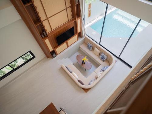 an overhead view of a living room with a table at Villa Mar Pool Villa in Sathani Hat Yai
