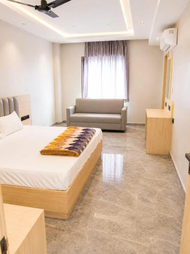 a hotel room with a bed and a couch at Hotel Radian INN in Gorakhpur