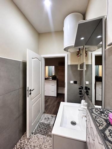 a kitchen with a white sink and a counter at Kael Apartment in Teplice