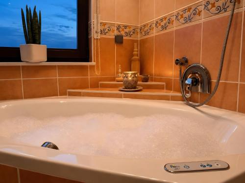 a bath tub in a bathroom with a window at Ferienwohnung Am Wäldchen in Vöhl