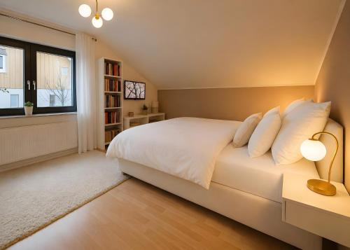 a bedroom with a white bed and a window at Ferienwohnung Am Wäldchen in Vöhl
