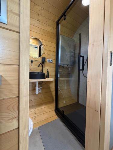 a small bathroom with a shower and a sink at Tatry Panorama House in Zuberec