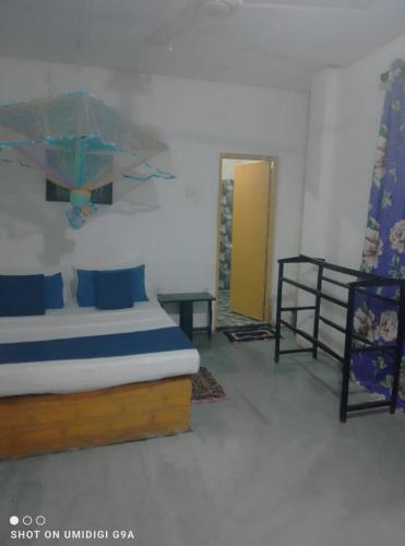 a bedroom with a bed and a table and a door at Rithu Homestay in Sigiriya