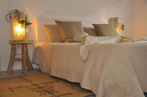 a bedroom with a bed and a table with a lamp at Ecocirer Guest House in Sóller