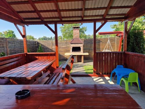 a pavilion with a picnic table and a playground at Casa Rodica Turda in Turda