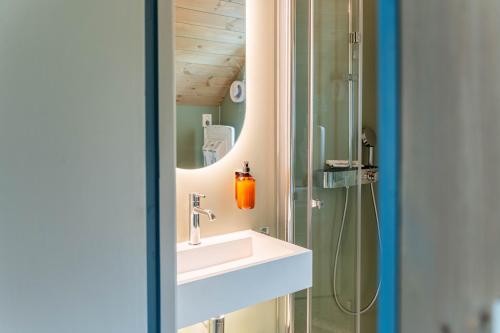 a bathroom with a sink and a shower at Reineblikk in Moskenes