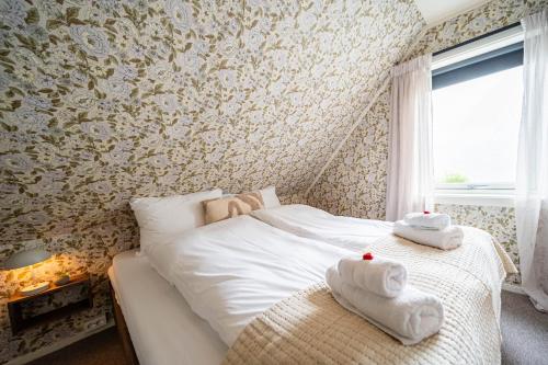 a bedroom with a bed with towels on it at Reineblikk in Moskenes