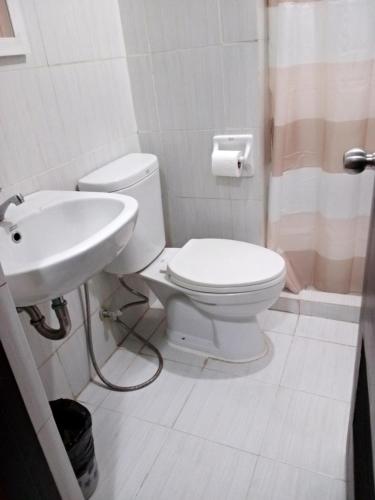a bathroom with a toilet and a sink at Compact Studio Unit l Mesaverte Residences 8th Floor in Pontud