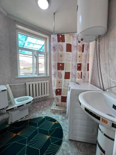 a bathroom with a sink and a toilet at Terme Guesthouse in Naryn