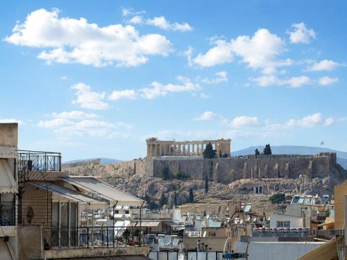 a view of the acropolis from the city of athens at Aether Athens Urban Hotel in Athens