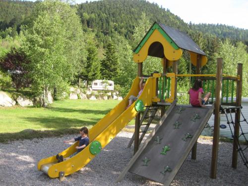 a group of children playing on a playground at camping du haut des bluches in La Bresse