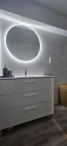 a bathroom with a sink and a large mirror at Benning Haus Gandia in Gandía