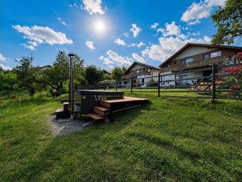 a picnic table in the grass in front of a building at Casa Aluna Duo in Bran