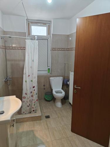 a bathroom with a toilet and a sink at Harys Home in Korinos