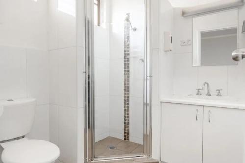 a bathroom with a shower with a toilet and a sink at Nicholas Royal Motel - Hay CBD in Hay