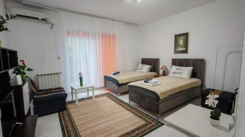 a living room with two beds and a couch at Koviljača park in Banja Koviljača