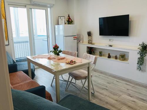 a living room with a table and a refrigerator at Apartament Pelicanul in Tulcea