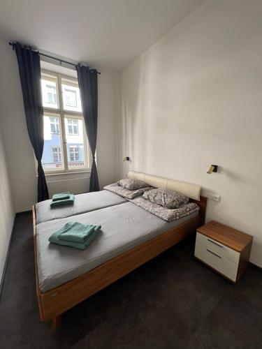 a bedroom with a large bed with a window at Perlová Suites in Pilsen