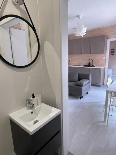 a bathroom with a sink and a mirror on the wall at Seaside Harmony in Pogorzelica