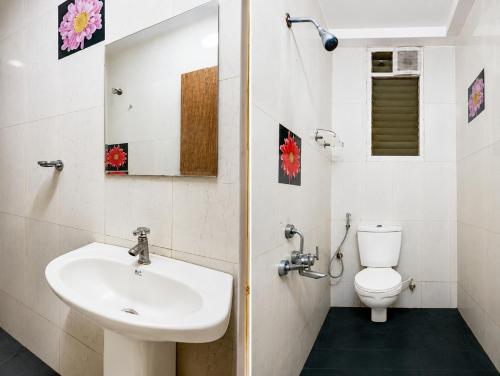 a bathroom with a sink and a toilet at Luxe By Lotels in Chennai
