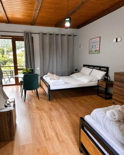 a bedroom with two beds and a table and chairs at Arazani in Lagodekhi