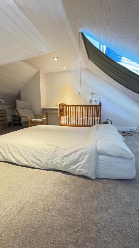 a large bed in a room with a window at Dryden Gardens in Edinburgh