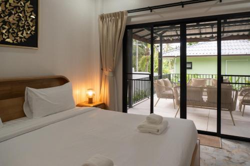 a bedroom with a bed with two towels on it at Luxury Villa with Private Pool, Srithanu in Ko Kong Nui