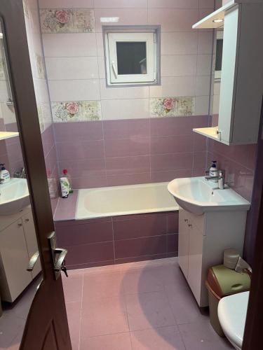 a bathroom with a tub and a sink at Apartament Crângului Dej in Dej