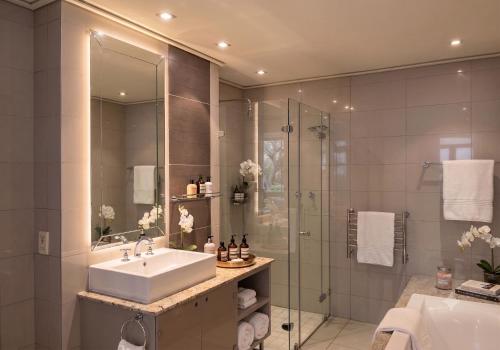 a bathroom with a sink and a shower at Cape Royale Luxury Suite 602 in Cape Town