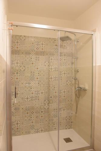 a bathroom with a shower with a glass door at Casa Nora in Valsinni