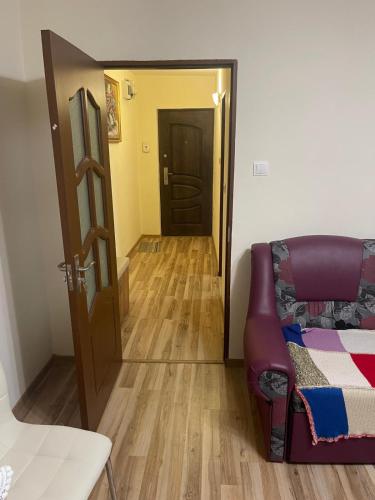 a living room with a couch and a door at Apartament Crângului Dej in Dej