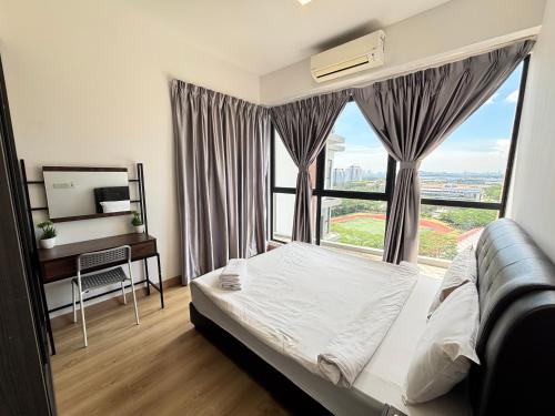 a bedroom with a bed and a desk and a window at Bell Suites by Salaam Suites in Sepang