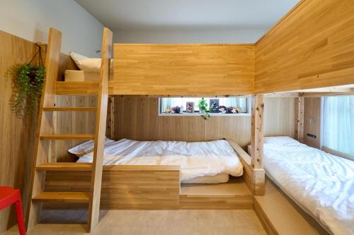 a bedroom with two bunk beds and a window at Inside Sangreen - Vacation STAY 22712 in Tokyo