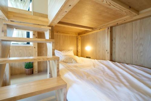 a bed in a room with wooden walls at Inside Sangreen - Vacation STAY 22714 in Tokyo