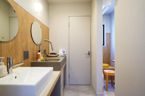 a bathroom with a sink and a mirror at Inside Sangreen - Vacation STAY 22714 in Tokyo