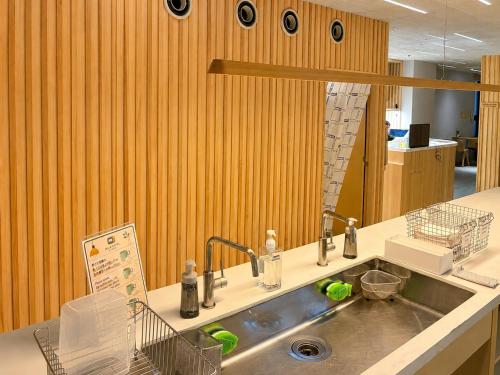 a kitchen counter with a sink and a mirror at 女性専用 Woman Only capsule MAJA HOTEL KYOTO マヤホテルキョウト in Kyoto
