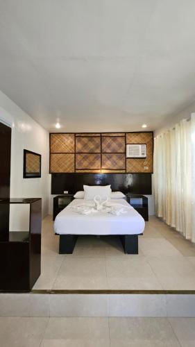 a bedroom with a large white bed in a room at Agta Beach Resort in Biliran