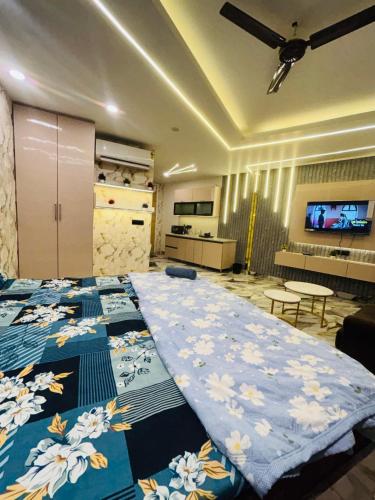 a bedroom with two beds with blue and white sheets at Nior luxury stays in Ghaziabad
